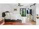 Bright bedroom features a bed, TV, and glass doors with backyard views at 1220 S Elm St, Denver, CO 80246