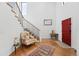 Inviting entryway with a red front door, open staircase, and wood flooring at 1220 S Elm St, Denver, CO 80246