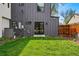 Modern home exterior with stylish siding, black trim, and a well-kept lawn, creating a welcoming curb appeal at 1220 S Elm St, Denver, CO 80246