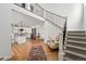 Bright, open foyer with staircase, hardwood floors, and view into a modern, well-equipped kitchen at 1220 S Elm St, Denver, CO 80246