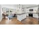 Open concept kitchen with white cabinets, stainless appliances, and dining area with abundant natural light at 1220 S Elm St, Denver, CO 80246