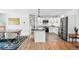 Bright kitchen with a marble island, white cabinetry, modern appliances, and adjacent dining space at 1220 S Elm St, Denver, CO 80246