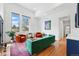 Spacious living room with large windows, colorful accents, and wood floors at 1220 S Elm St, Denver, CO 80246