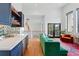 Living room and bar featuring wood floors, bar seating, and lots of natural light at 1220 S Elm St, Denver, CO 80246