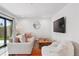 Comfortable living room features a plush sofa, oversized beanbag chair, and seamless access to the outdoors at 1220 S Elm St, Denver, CO 80246