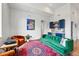 Large, bright living room with colorful accents, bar area, and new lighting at 1220 S Elm St, Denver, CO 80246