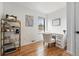 Home office with wood floors, built-in desk and cabinetry, and lots of natural light at 1220 S Elm St, Denver, CO 80246