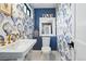 Charming powder room with decorative wallpaper, stylish fixtures, and a large mirror at 1220 S Elm St, Denver, CO 80246