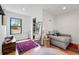Sitting area in the main bedroom with floor-to-ceiling mirror, window, and stylish rug at 1220 S Elm St, Denver, CO 80246
