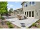 Inviting backyard with stone patio, dining set, and lush green landscaping, perfect for entertaining at 5586 Colorow Dr, Morrison, CO 80465