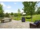 Serene backyard with paver patio, seating, and views of the lush greenery at 5586 Colorow Dr, Morrison, CO 80465