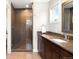 Bathroom with a glass-enclosed shower, dark wood vanity, and contemporary fixtures at 5586 Colorow Dr, Morrison, CO 80465