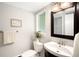Cozy bathroom featuring decorative mirror, fresh white towels, and modern sink at 5586 Colorow Dr, Morrison, CO 80465