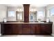 Double vanity bathroom with dual mirrors, dark wood cabinets, and tile floor at 5586 Colorow Dr, Morrison, CO 80465