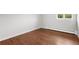 Bright bedroom featuring hardwood floors, a window, radiator, and neutral walls at 5586 Colorow Dr, Morrison, CO 80465