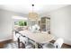 Elegant dining room with modern lighting fixtures offering a view to the cozy living room at 5586 Colorow Dr, Morrison, CO 80465