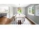 Bright dining room featuring hardwood floors, modern lighting, and a view to the lush backyard at 5586 Colorow Dr, Morrison, CO 80465