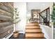 Stylish entryway featuring a wooden staircase, rustic wood accent wall, and modern decor at 5586 Colorow Dr, Morrison, CO 80465