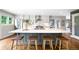 Bright eat-in kitchen featuring a large island, modern appliances, and stainless steel hood at 5586 Colorow Dr, Morrison, CO 80465