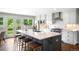 Stylish kitchen featuring an island with seating, stainless steel appliances, and white cabinetry at 5586 Colorow Dr, Morrison, CO 80465