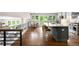 Open kitchen and dining area with a large island, modern appliances, and wood floors at 5586 Colorow Dr, Morrison, CO 80465