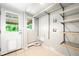 Laundry room featuring wire shelving, utility sink hookups, and exterior door at 5586 Colorow Dr, Morrison, CO 80465