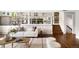 Open concept living room with hardwood floors, modern shelving, and access to the kitchen at 5586 Colorow Dr, Morrison, CO 80465