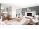 Open-concept living room with a fireplace, hardwood floors, and seamless flow to the kitchen at 5586 Colorow Dr, Morrison, CO 80465