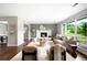 Bright living room with large windows, a white brick fireplace, and hardwood floors at 5586 Colorow Dr, Morrison, CO 80465