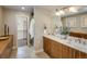 Bathroom featuring double sinks, marble countertop, modern fixtures, and access to shower and closet at 1231 Cedar Ave, Boulder, CO 80304