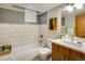 Stylish bathroom features subway tile surround in tub and modern vanity with white countertop and vessel sink at 1231 Cedar Ave, Boulder, CO 80304