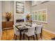 Elegant dining room featuring a stone fireplace, hardwood floors, and large window letting in natural light at 1231 Cedar Ave, Boulder, CO 80304