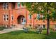 Beautiful historic brick school building with manicured lawn, inviting entrance, and mature trees at 1231 Cedar Ave, Boulder, CO 80304