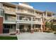 Apartment building showcasing multiple levels of balconies, an outdoor seating area, and verdant landscaping at 1231 Cedar Ave, Boulder, CO 80304