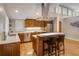 Modern kitchen featuring hardwood floors, an island with seating, stainless steel appliances, and plenty of storage at 1231 Cedar Ave, Boulder, CO 80304