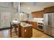 Modern kitchen featuring stainless steel appliances, a breakfast bar, and wood cabinets at 1231 Cedar Ave, Boulder, CO 80304