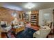 Inviting library area features exposed brick, comfortable seating, bookshelves, and a cozy ambiance at 1231 Cedar Ave, Boulder, CO 80304