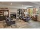 Inviting lounge area with fireplace, bookshelves, comfortable seating, and natural light at 1231 Cedar Ave, Boulder, CO 80304