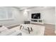 Finished basement area with an entertainment center and a sofa with an ottoman at 6694 E 129Th Ave, Thornton, CO 80602