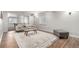 Finished basement area with a sofa, coffee table, and a small game table in the background at 6694 E 129Th Ave, Thornton, CO 80602