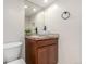 Well-lit half bathroom with a modern vessel sink, providing a functional and stylish space for guests at 6694 E 129Th Ave, Thornton, CO 80602