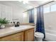 Bathroom featuring a single sink vanity, a toilet, and a shower/tub combo with a decorative shower curtain at 6694 E 129Th Ave, Thornton, CO 80602