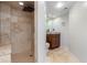 Updated bathroom featuring a walk-in shower with tiled surround and a vessel sink vanity, showcasing modern elegance at 6694 E 129Th Ave, Thornton, CO 80602