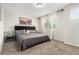 Bedroom with a dark-colored upholstered bed, a window with sheer curtains, and a landscape picture on the wall at 6694 E 129Th Ave, Thornton, CO 80602