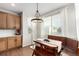 Charming dining area featuring a wooden table, bench seating, and natural light at 6694 E 129Th Ave, Thornton, CO 80602