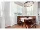 Inviting dining area offering bench seating, a modern chandelier, and natural light at 6694 E 129Th Ave, Thornton, CO 80602