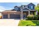 Charming two-story home featuring a three car garage, brick accents, and landscaped yard at 6694 E 129Th Ave, Thornton, CO 80602