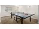 Basement game room featuring a ping pong table with paddles and net, providing an excellent space for recreation at 6694 E 129Th Ave, Thornton, CO 80602