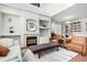 Bright and airy living room with a fireplace, built-in shelves and modern furnishings at 6694 E 129Th Ave, Thornton, CO 80602