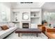 Bright living room featuring a fireplace, built-in shelves and plenty of natural light at 6694 E 129Th Ave, Thornton, CO 80602